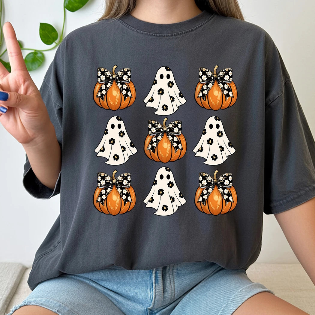 Person wearing a dark gray t-shirt with Halloween-themed graphics of pumpkins and ghosts.