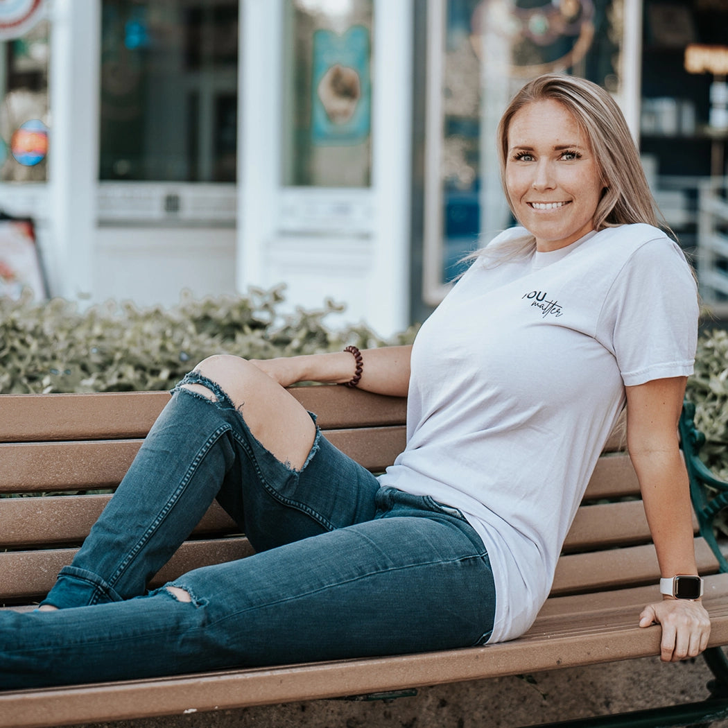 Model wearing a lavender graphic apparel shirt that says You matter. To the person behind me: you are amazing, beautiful and enough. Remember that. The design is text only in black.