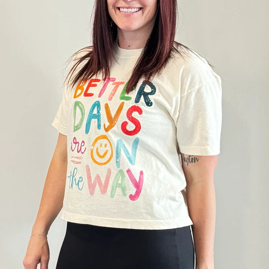 Womens graphic tshirts. Woman wearing a crop top graphic tee that says better days are on the way.