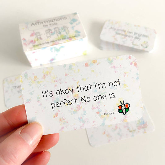 Each box contains 52 affirmation cards for children written by a teacher and approved by a psychologist. Each card also contains children's original artwork. WORDS ARE POWERFUL. Car showing says It's okay that I'm not perfect. No one is. 