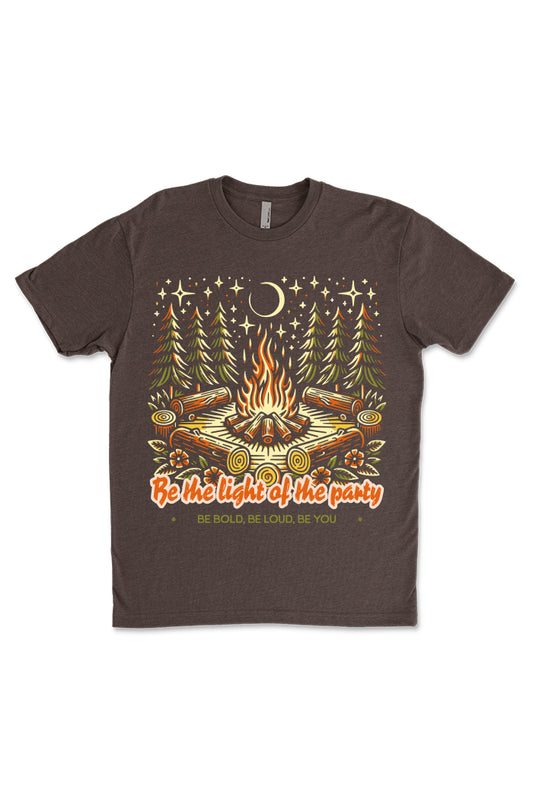 Soft brown graphic t-shirt displaying a cheerful graphic of a campfire with the phrase 'Be the Light of the Party' in bold letters, ideal for casual gatherings and camping trips.