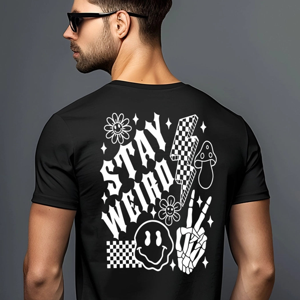 Black shirt with white design. Checkered design with droopy smile face, lightning bulb, mushroom, flowers and skeleton fingers. Shirt says stay weird. 