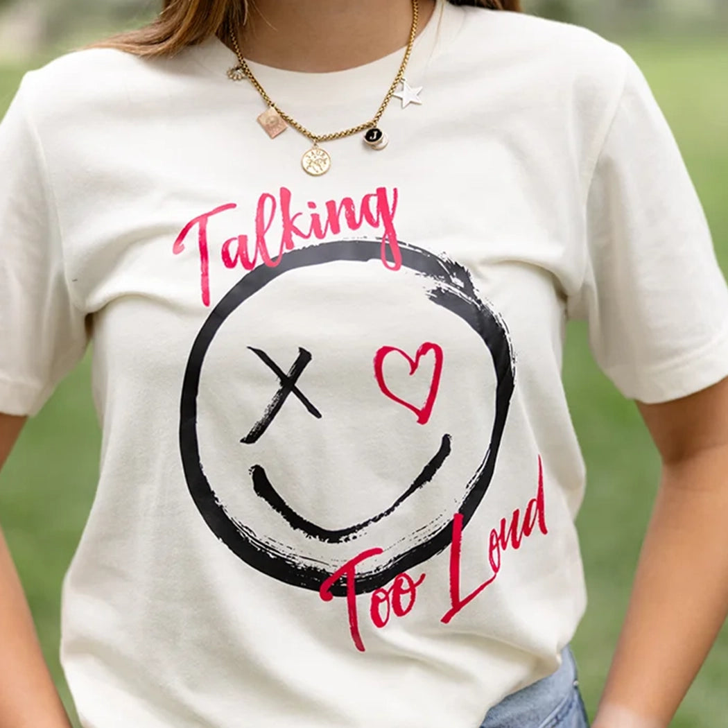 Tan shirt with the Talking Too Loud logo.