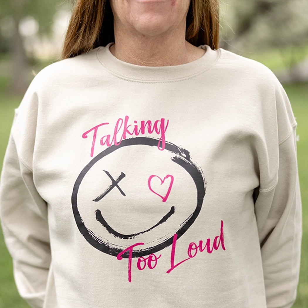 Woman wearning talking too loud crewneck in tan