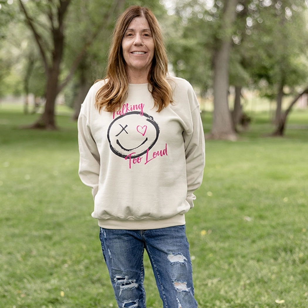 Woman wearning talking too loud crewneck in tan