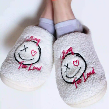 White slippers with Talking Too Loud logo.