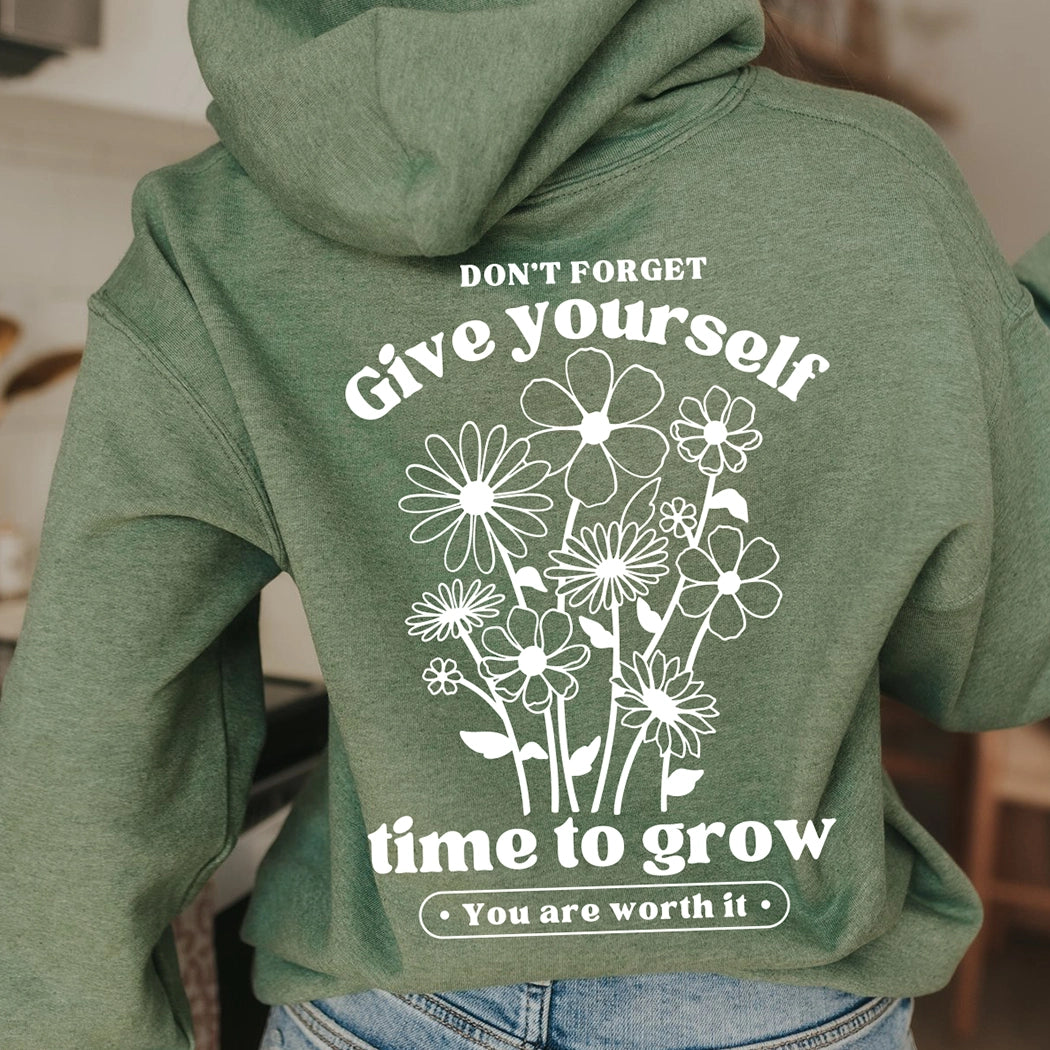 Don't forget give yourself time to grow. You are worth it. Positive message shirt. Black design on a green hoodie. Gildan hoodie. You are worth it with flower on front.