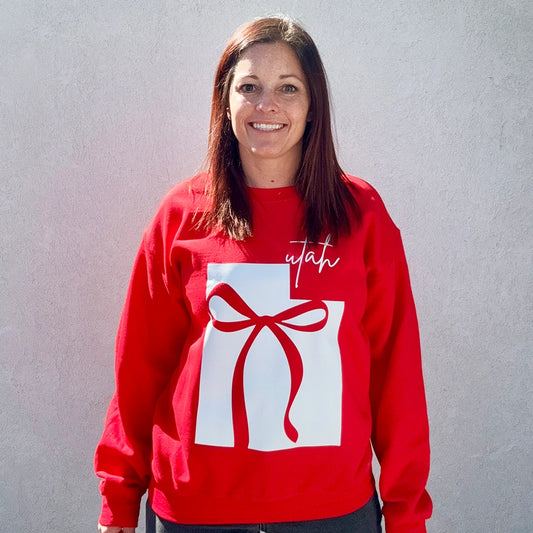 red sweatshirt with a graphic design of Utah and a bow