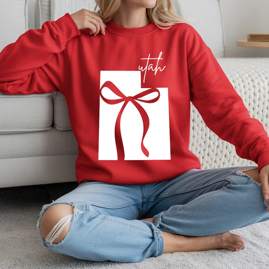 red sweatshirt with a graphic design of Utah and a bow