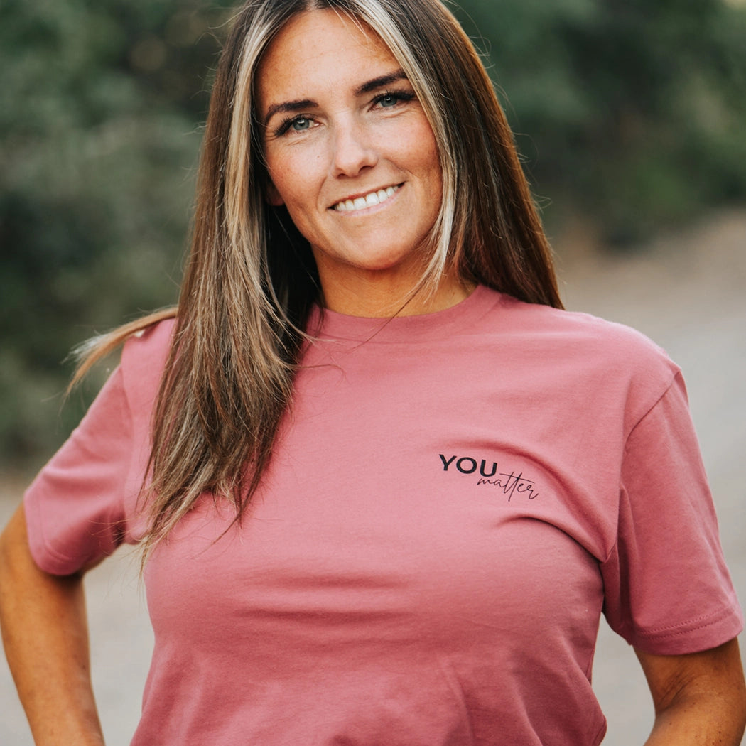 Model wearing a mauve graphic apparel shirt that says You matter. To the person behind me: you are amazing, beautiful and enough. Remember that. The design is text only in black.