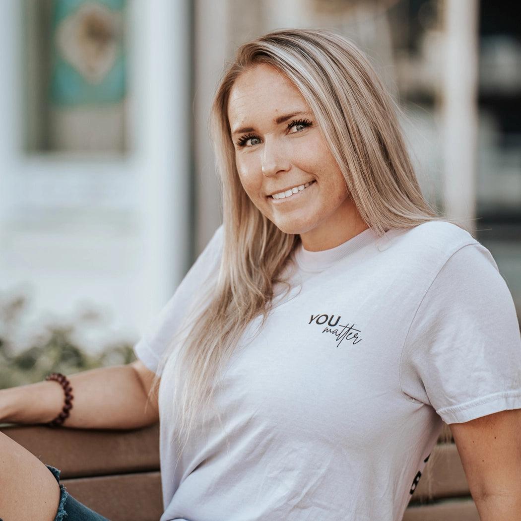 Model wearing lavender shirt that says You matter. To the person behind me: you are amazing, beautiful and enough. Remember that. The design is text only in black.