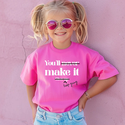 Neon pink graphic graphic apparel shirt with white text that says You'll never make it. Give up. The never is crossed out and the give up is crossed out with keep going written next to it. 