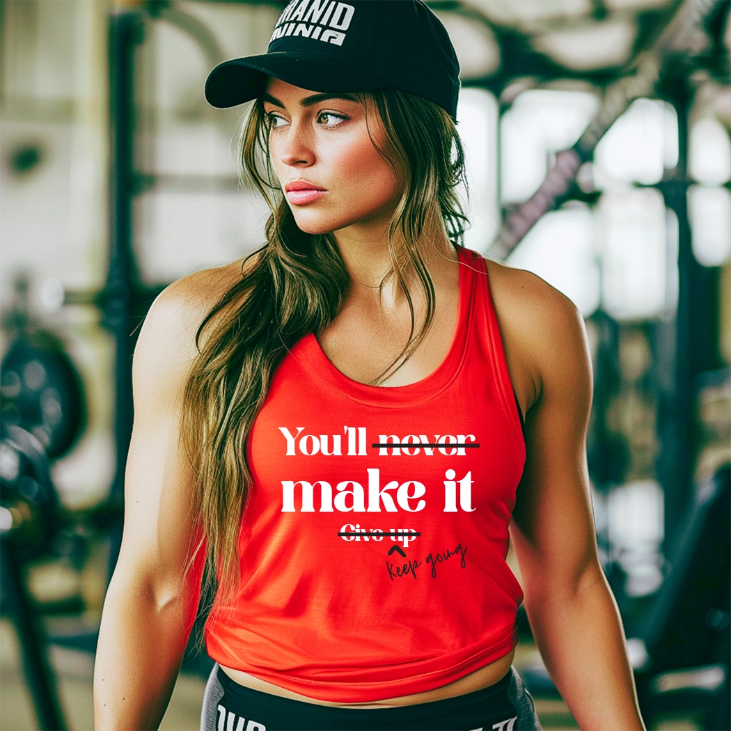 The workout tank has the text "You'll Make It. Keep Going. " printed on it. The text is in a large, bold font and is centered on the tank. The tank is a light gray color and appears to be made of a soft, breathable fabric. It has a racerback style, which is designed to provide a full range of motion for the wearer. The tank is also moisture-wicking, which helps to keep the wearer cool and dry during exercise.