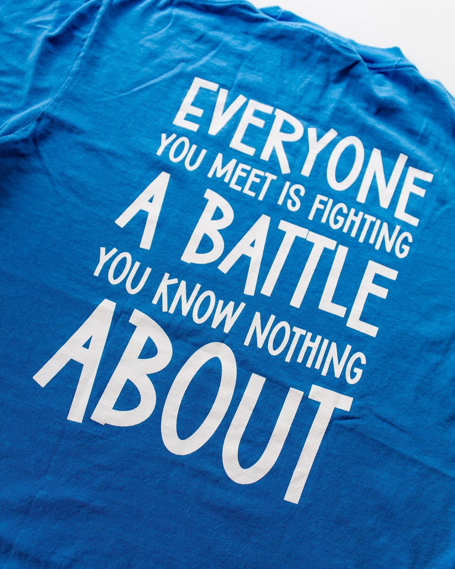Be Kind blue tshirt. Back of shirt everyone you meet is fighting a battle you know nothing about